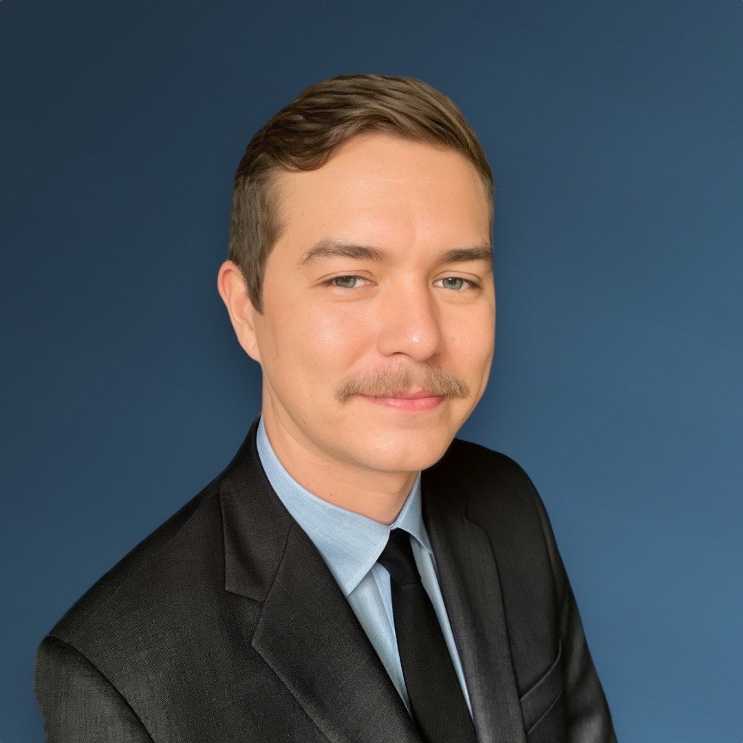 Portrait of John Johansson in a dark suit and light blue shirt